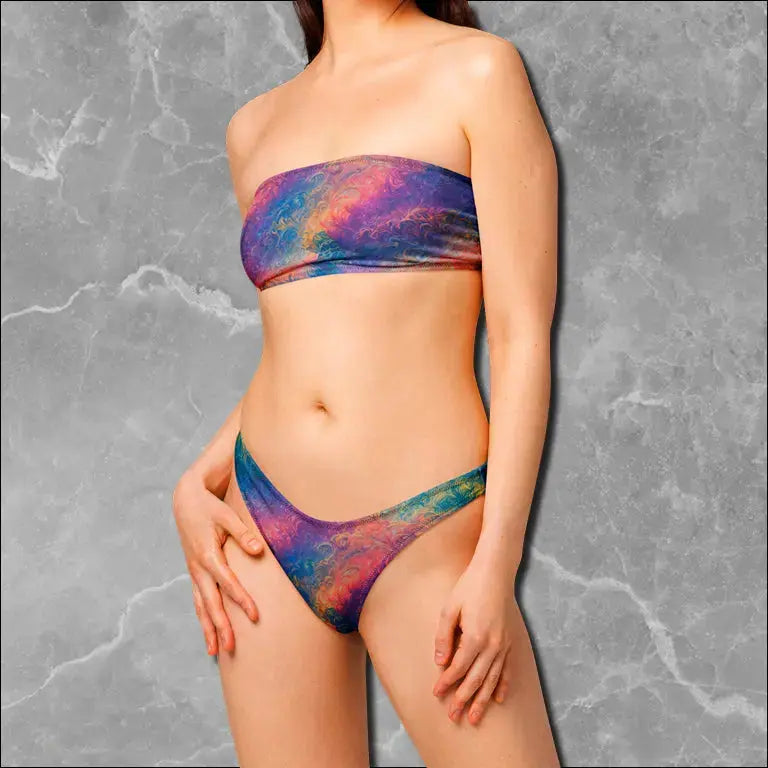 Model wearing a patterned bandeau bikini with a strapless top and high-cut bottoms